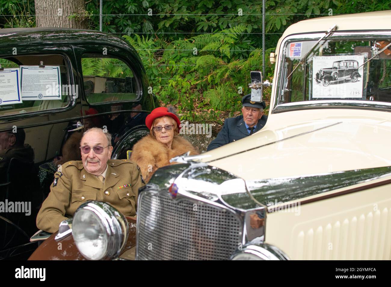Sheringham, Norfolk, UK - SEPTEMBER 14 2019: People in 1940s clothes rest by a Vauxhall Light Six during the 1940s weekend Stock Photo
