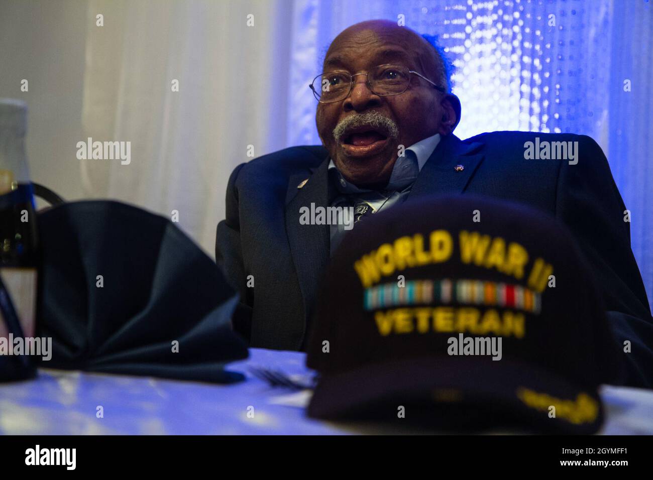 Pvt. Roosevelt Ruffin, a former Army Soldier who served with Company C, 614th Tank Destroyer Battalion, during World War II, interacts with guests at his 100th birthday celebration Feb. 1, 2020, in Virginia Beach, Virginia. Ruffin was one of the very first African-American tank destroyer unit members of the war. (U.S. Army Reserve photo by Sgt. 1st Class Javier Orona) Stock Photo
