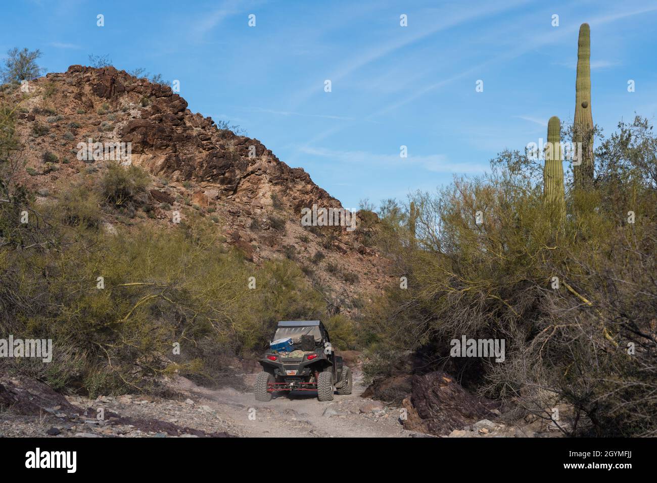 Following a 4WD UTV off-road vehicle on the Dripping Springs Trail in the Plomosa Mountains near Quartzsite, Arizona. Stock Photo