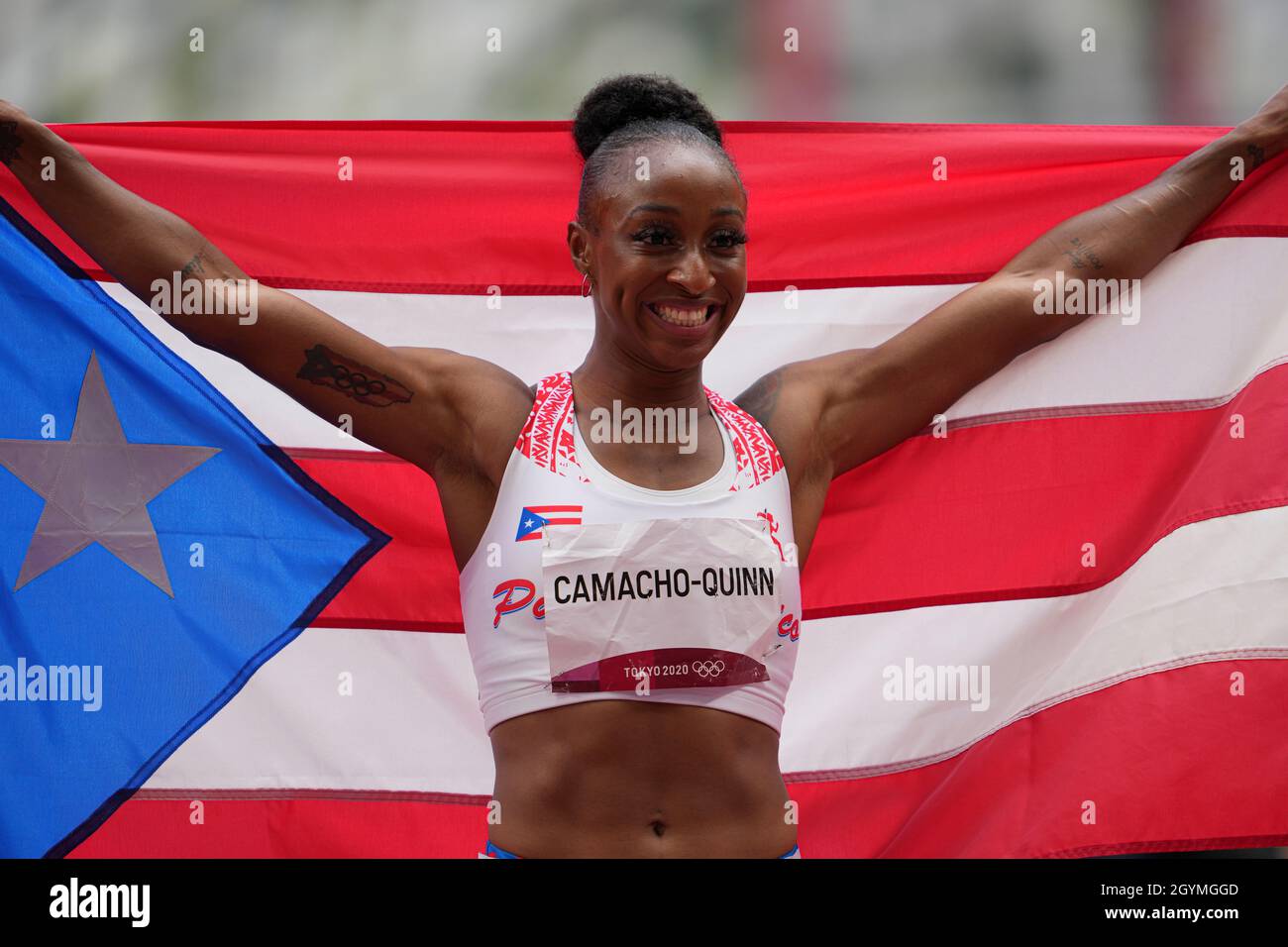 Jasmine CamachoQuinn with her country's flag after winning gold at the