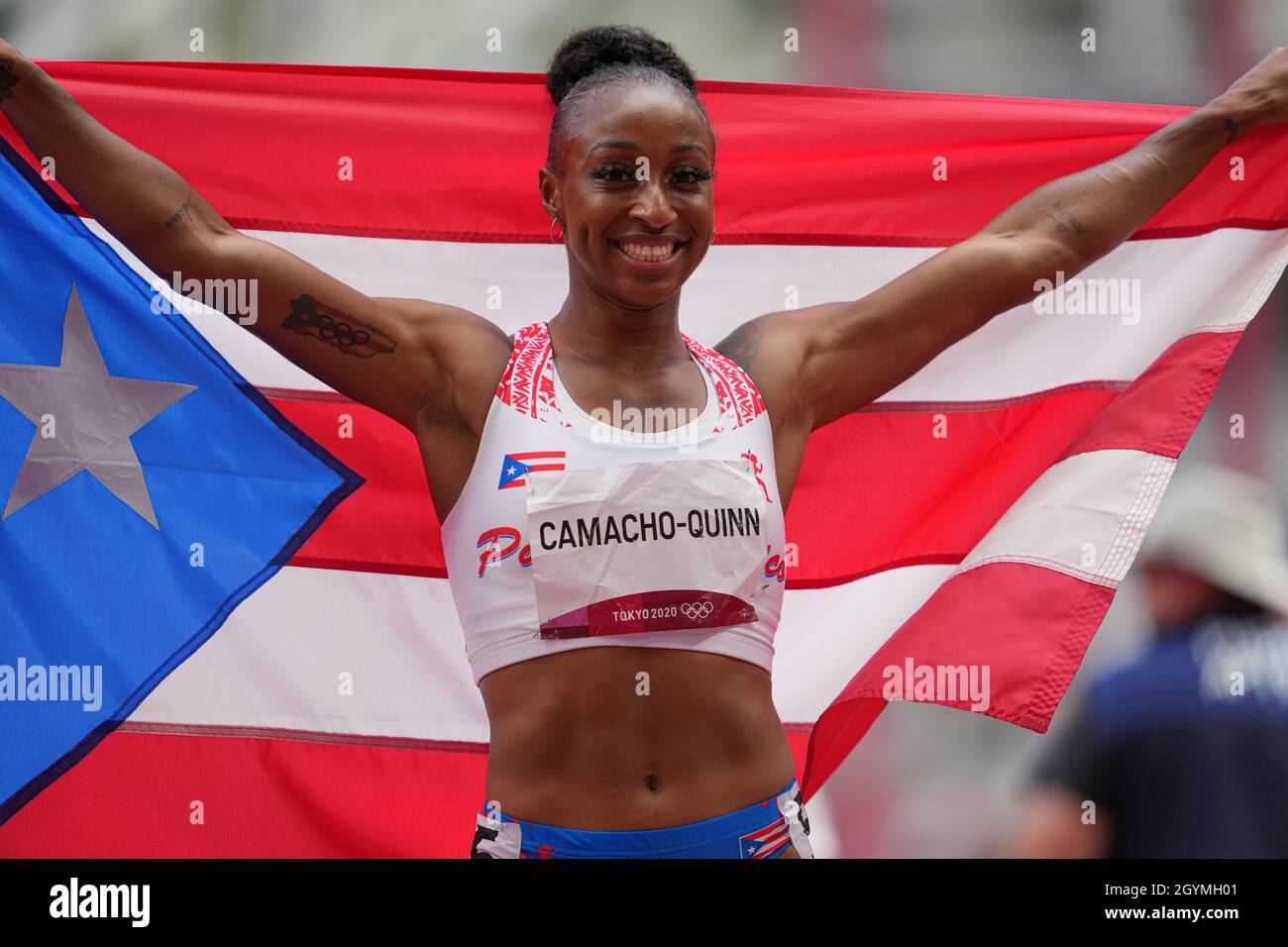 Jasmine CamachoQuinn with her country's flag after winning gold at the