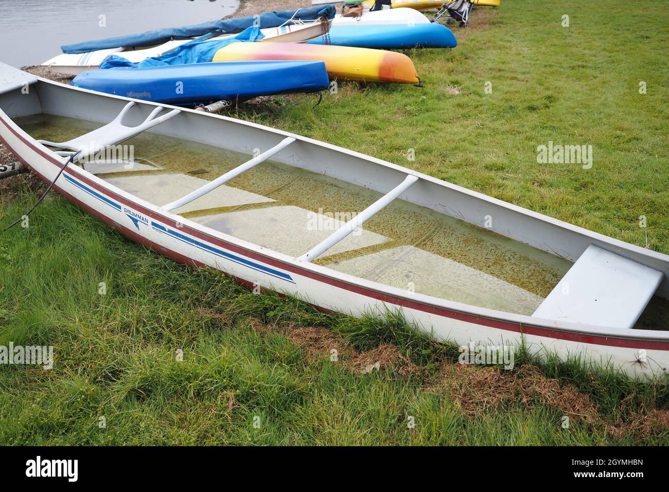 The canoe is completely waterlogged at this time. Someone should bail out the water. Stock Photo