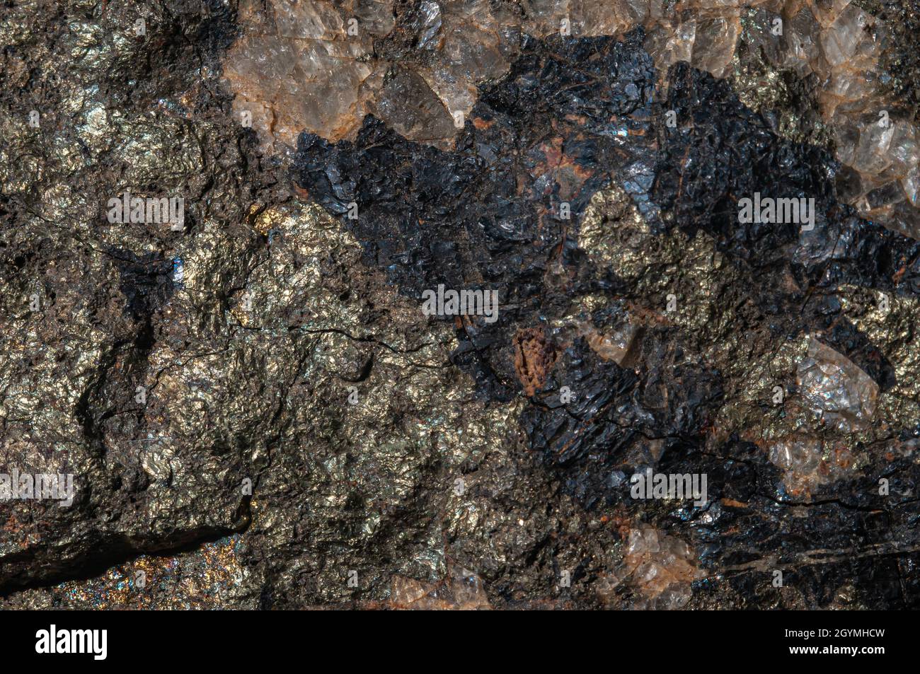 Textured surface of dark natural stone with various inclusions ...
