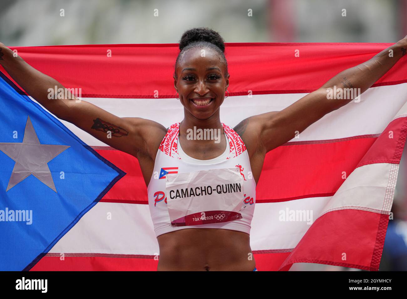 Jasmine CamachoQuinn with her country's flag after winning gold at the