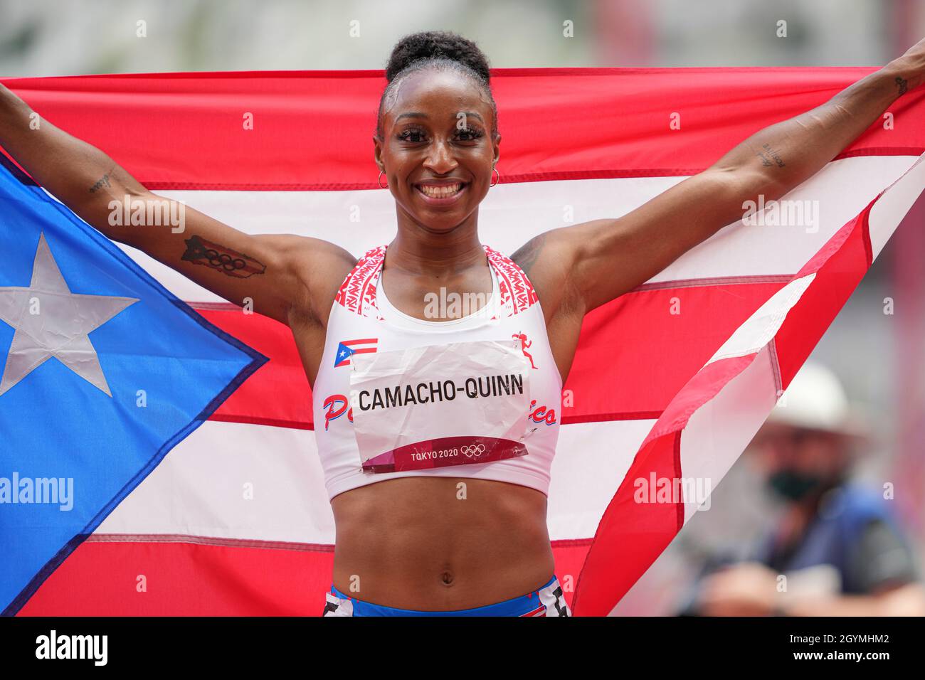 Jasmine CamachoQuinn with her country's flag after winning gold at the