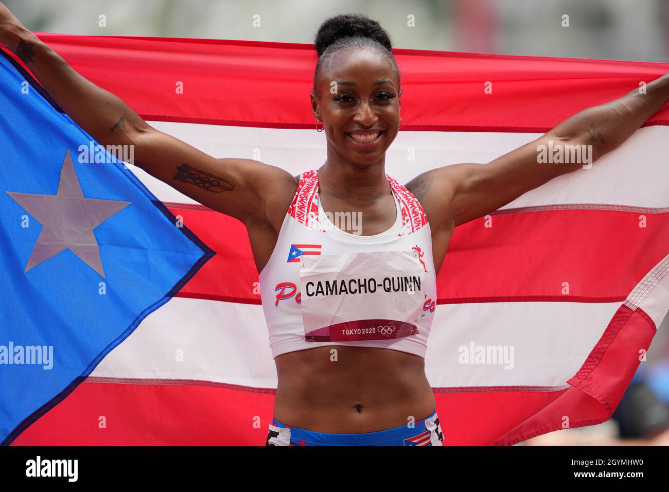 Jasmine CamachoQuinn with her country's flag after winning gold at the