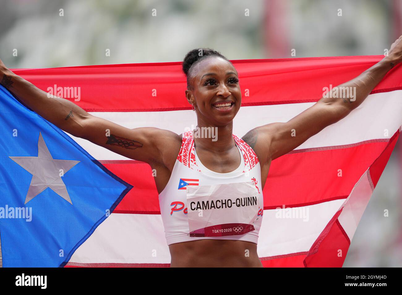 Jasmine CamachoQuinn with her country's flag after winning gold at the