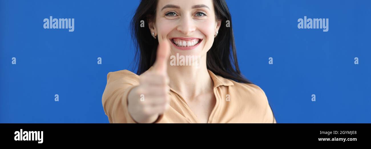 Portrait of smiling businesswoman showing thumbs up gesture Stock Photo