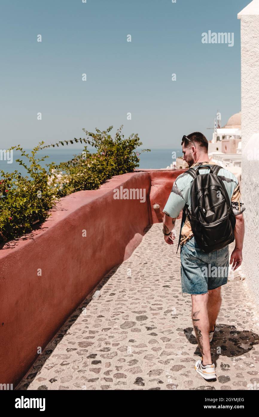 Back view tourist walking down hi-res stock photography and images - Alamy