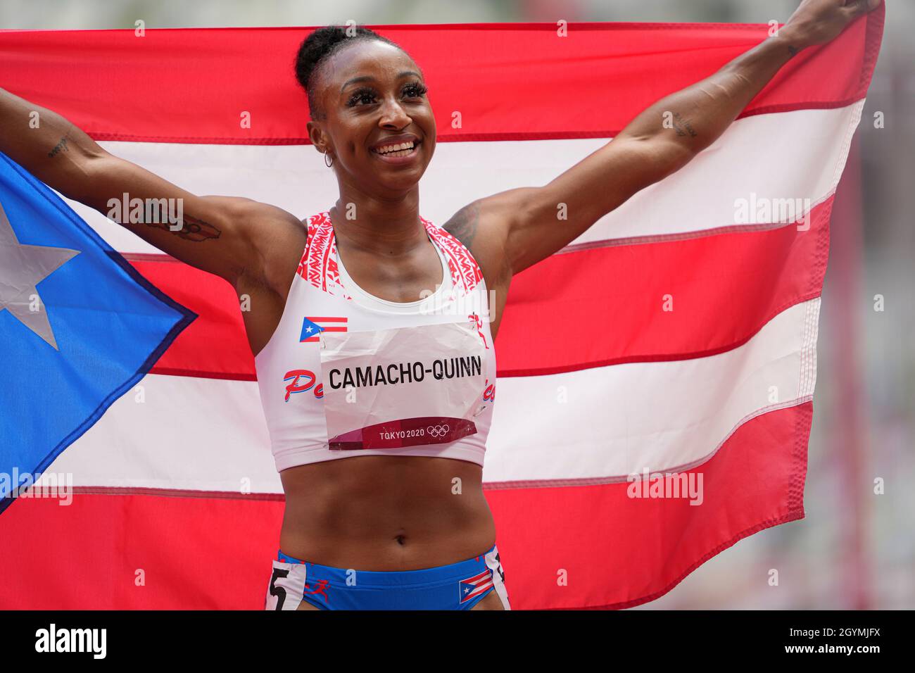 Jasmine CamachoQuinn with her country's flag after winning gold at the