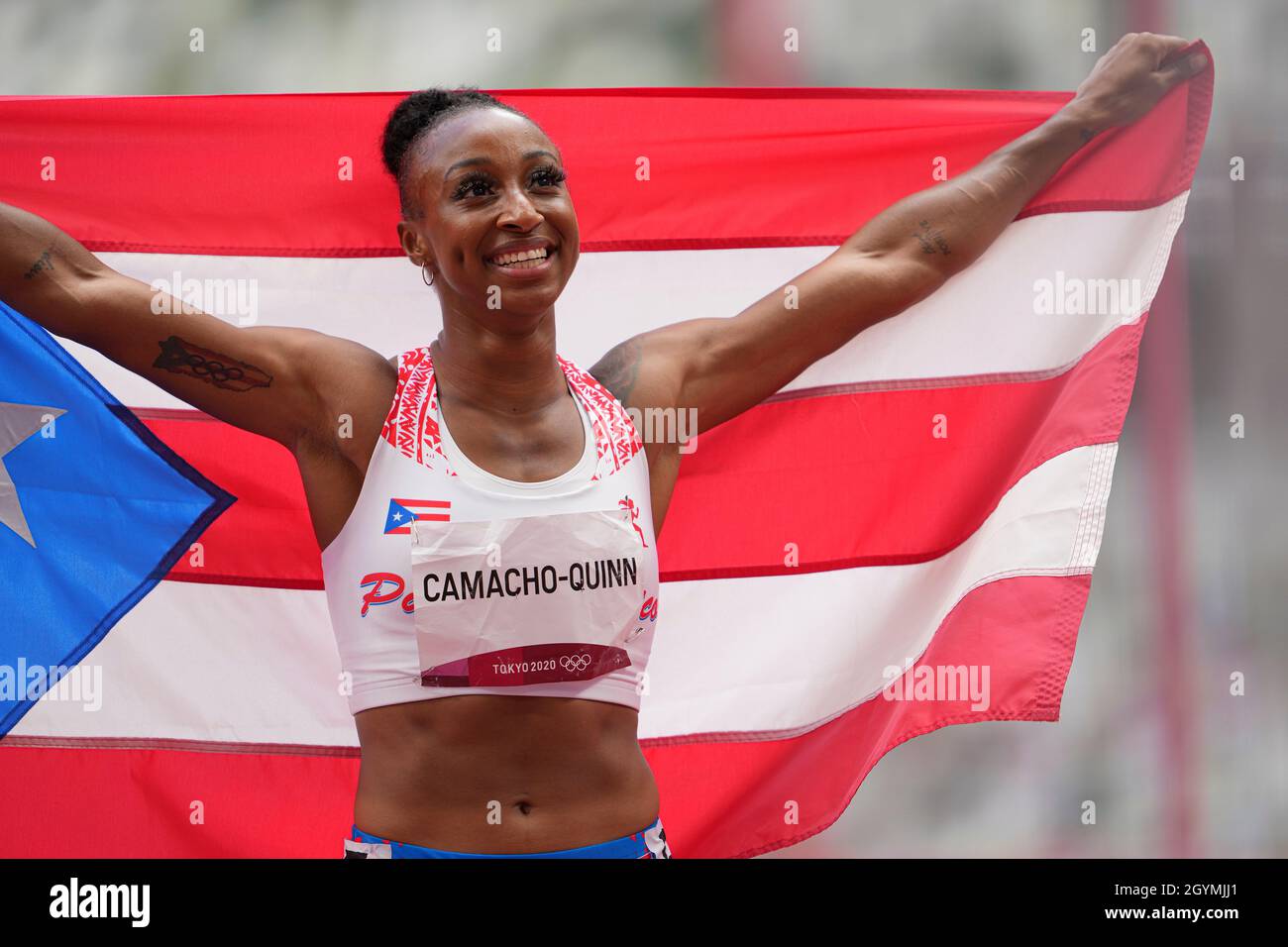 Jasmine CamachoQuinn with her country's flag after winning gold at the