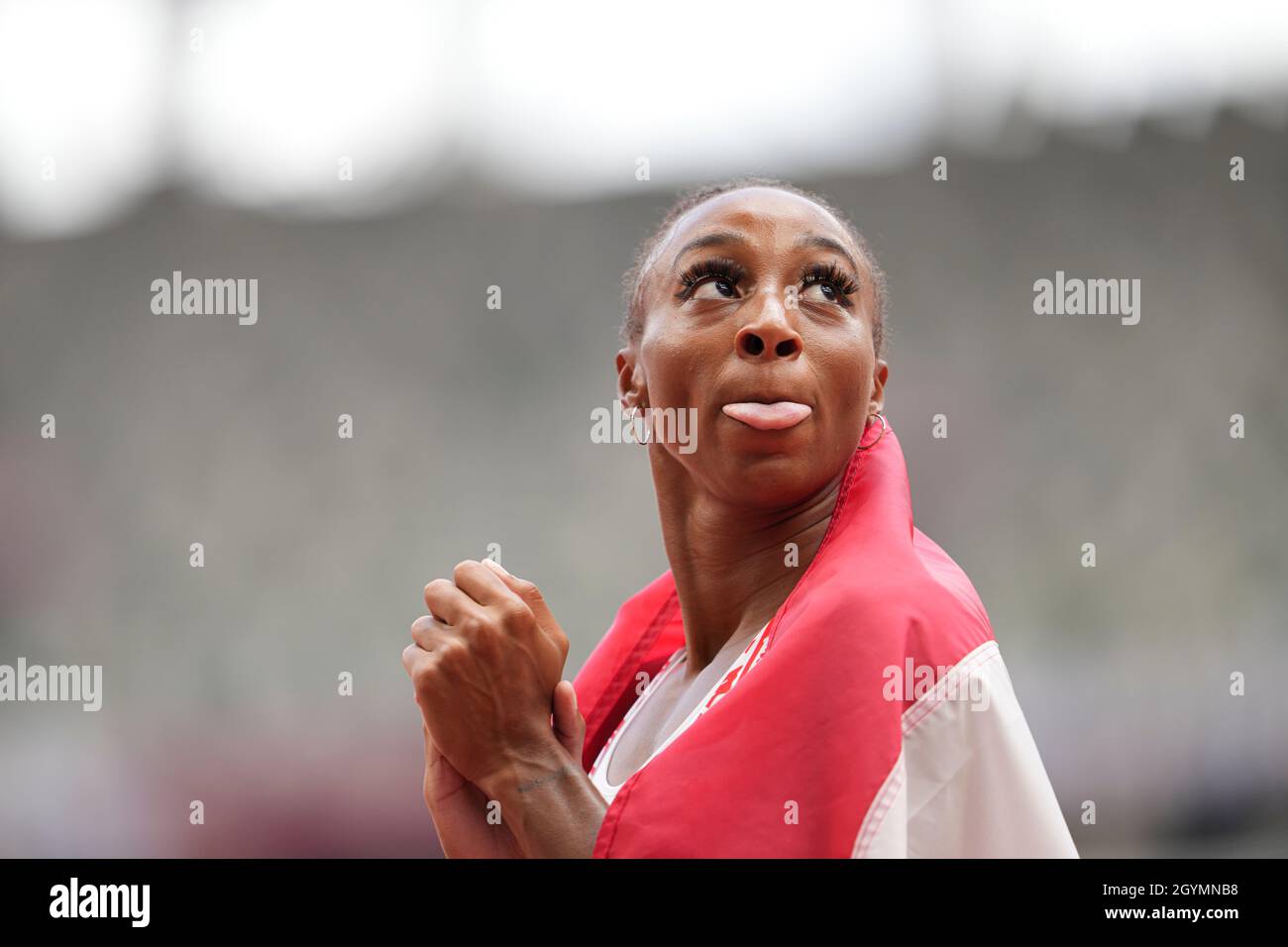 Jasmine CamachoQuinn with her country's flag after winning gold at the
