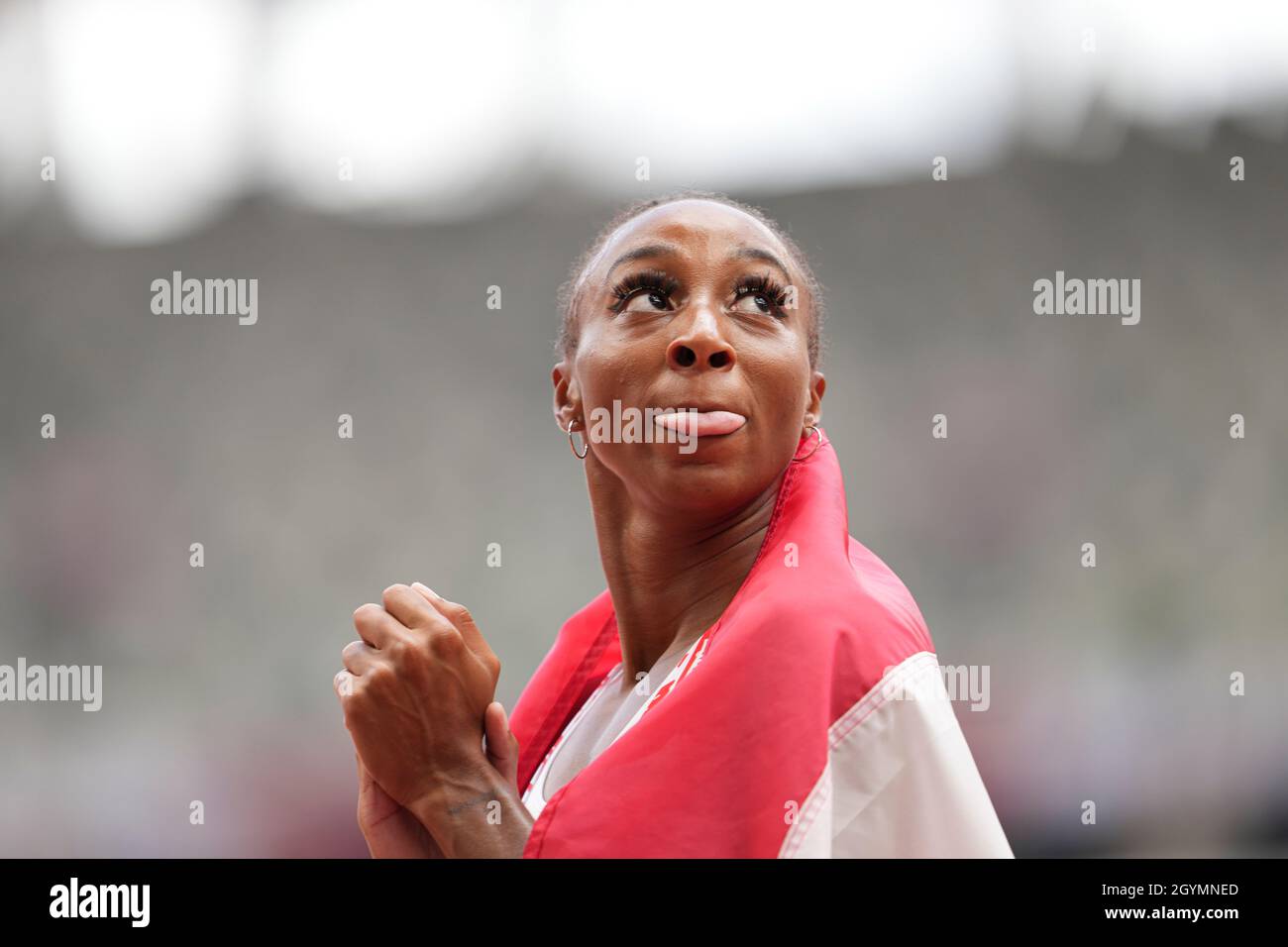 Jasmine CamachoQuinn with her country's flag after winning gold at the