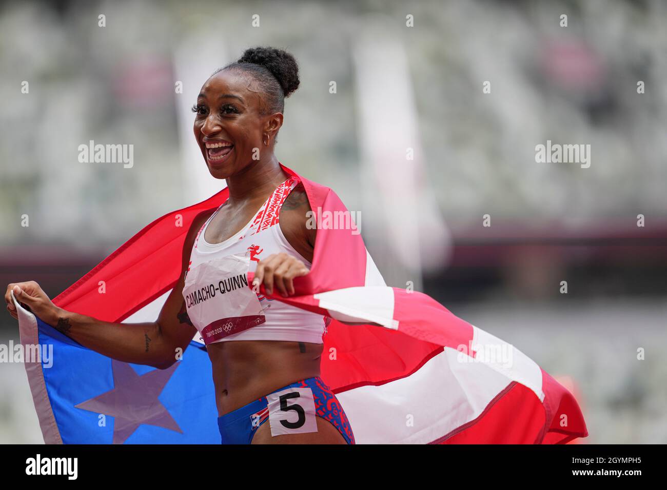Jasmine CamachoQuinn with her country's flag after winning gold at the