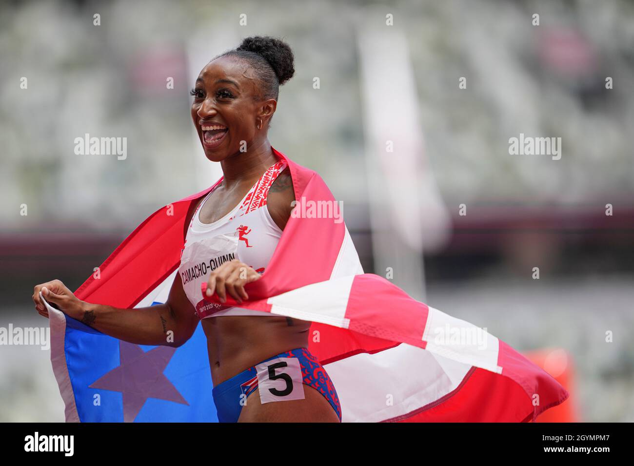 Jasmine CamachoQuinn with her country's flag after winning gold at the