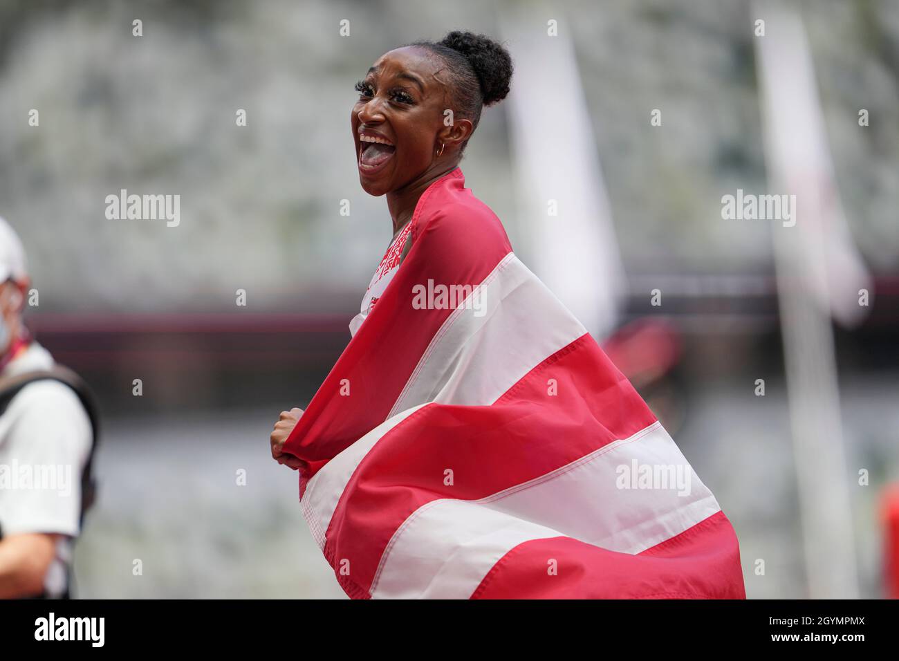 Jasmine CamachoQuinn with her country's flag after winning gold at the