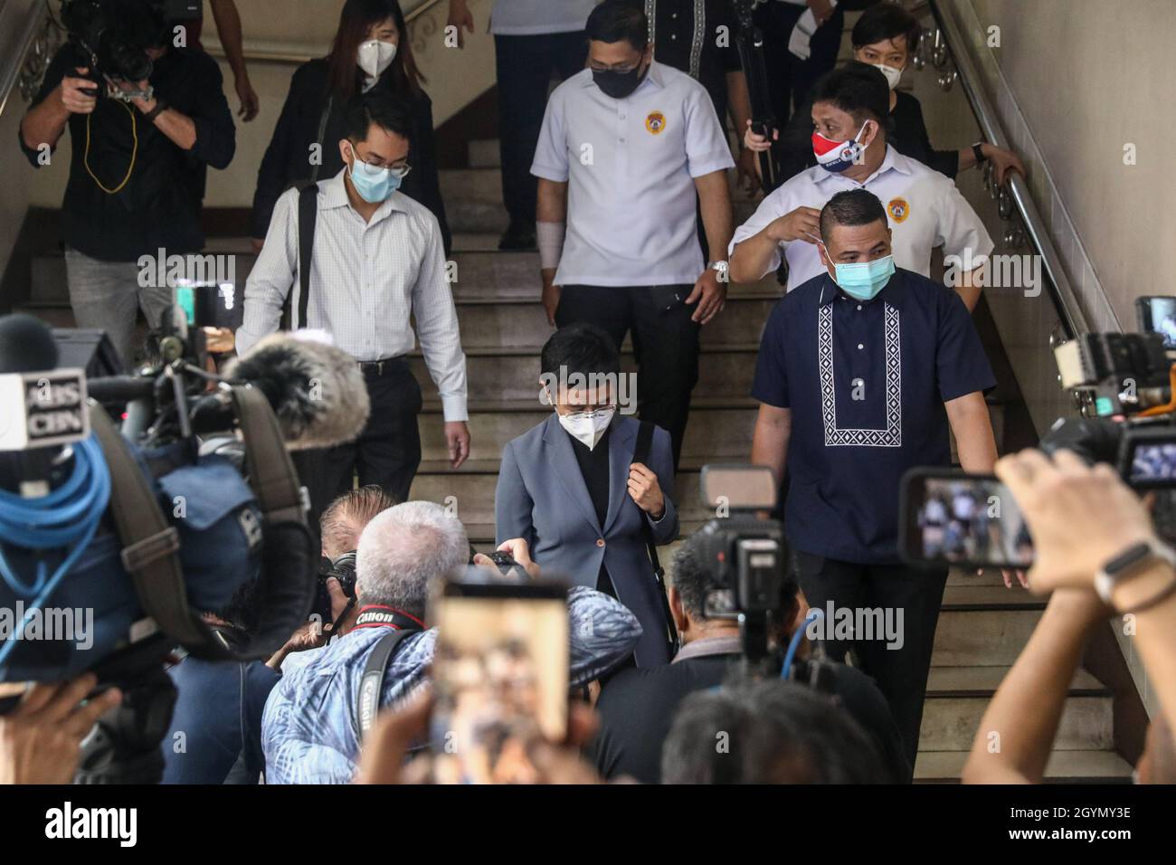 Rappler CEO and Executive Editor, Maria Ressa (center) wearing a protective mask is escorted to a media conference after a court hearing at the Manila Regional Trial Court, Philippines on Monday. June 15, 2020. The Manila court found Maria Ressa, her online news outfit Rappler Inc. and former reporter Reynaldo Santos Jr. guilty of cyber libel. Philippines. Stock Photo
