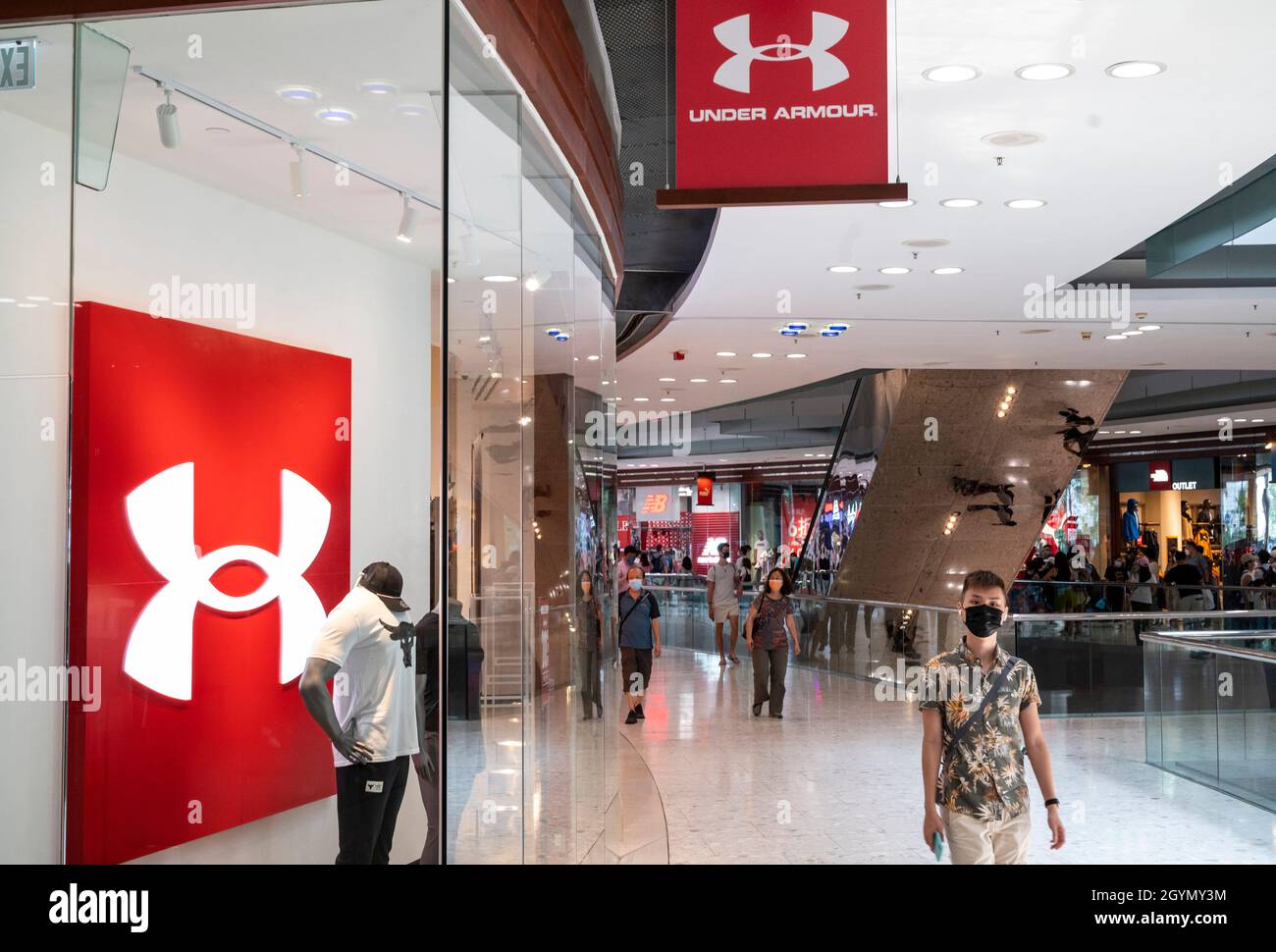 Shoppers walk past the American multinational clothing brand Under Armour  store in Hong Kong Stock Photo - Alamy