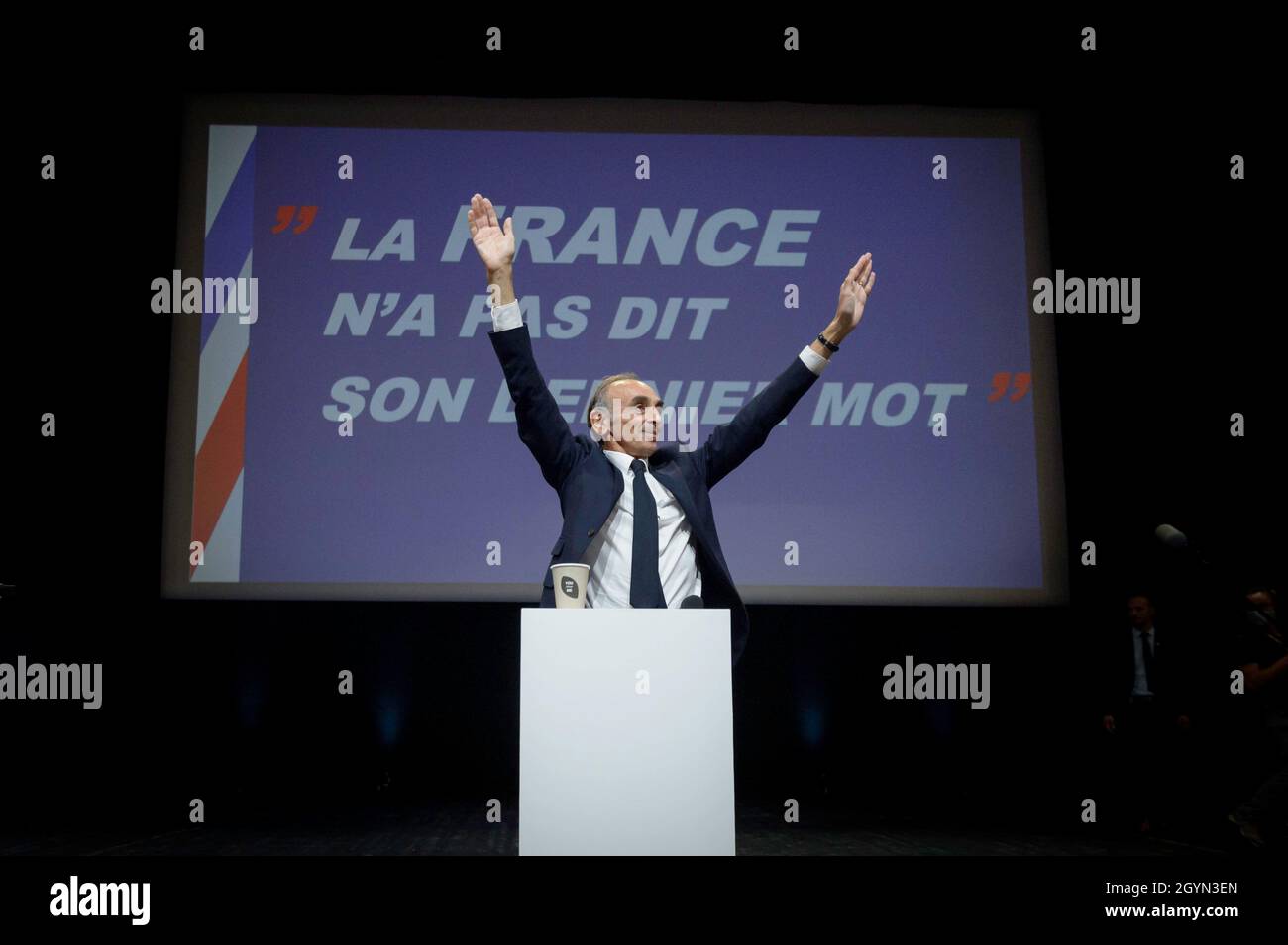 Eric Zemmour is seen on stage greeting his supporters. Eric Zemmour behaved like a candidate in an electoral campaign, even if he has not yet officially declared his entry in the race for the French presidential elections of 2022. Around him are now appearing new collaborators specialized in electoral campaigning and a merchandising marked 'Zemmour2022'. Since the recent poll that placed him on par with Marine Le Pen for the second round against Emmanuel Macron, his attitude and organization leave little room for doubt about his intentions. Stock Photo
