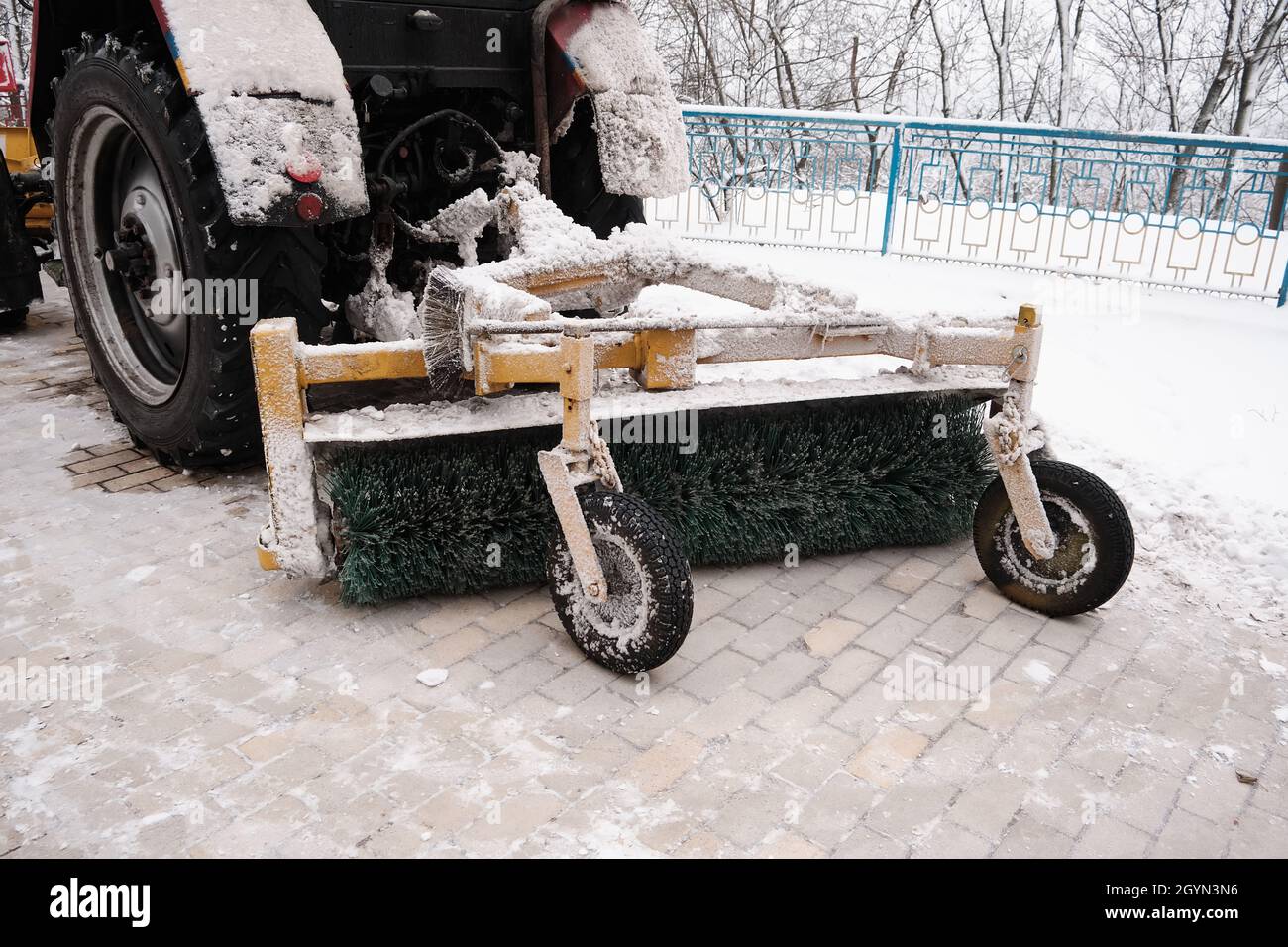 snow removal, urban. Tractor snowplow with a rotary brush and bucket