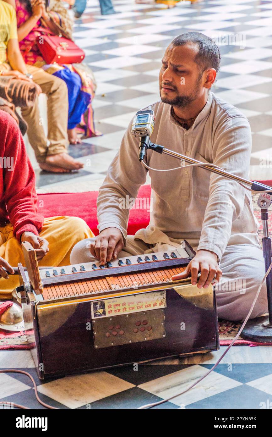 VRINDAVAN, INDIA - FEBRUARY 18, 2017: Musician playing on a pump organ in Krishna Balaram Mandir temple (Temple of ISKCON organisation) in Vrindavan, Stock Photo