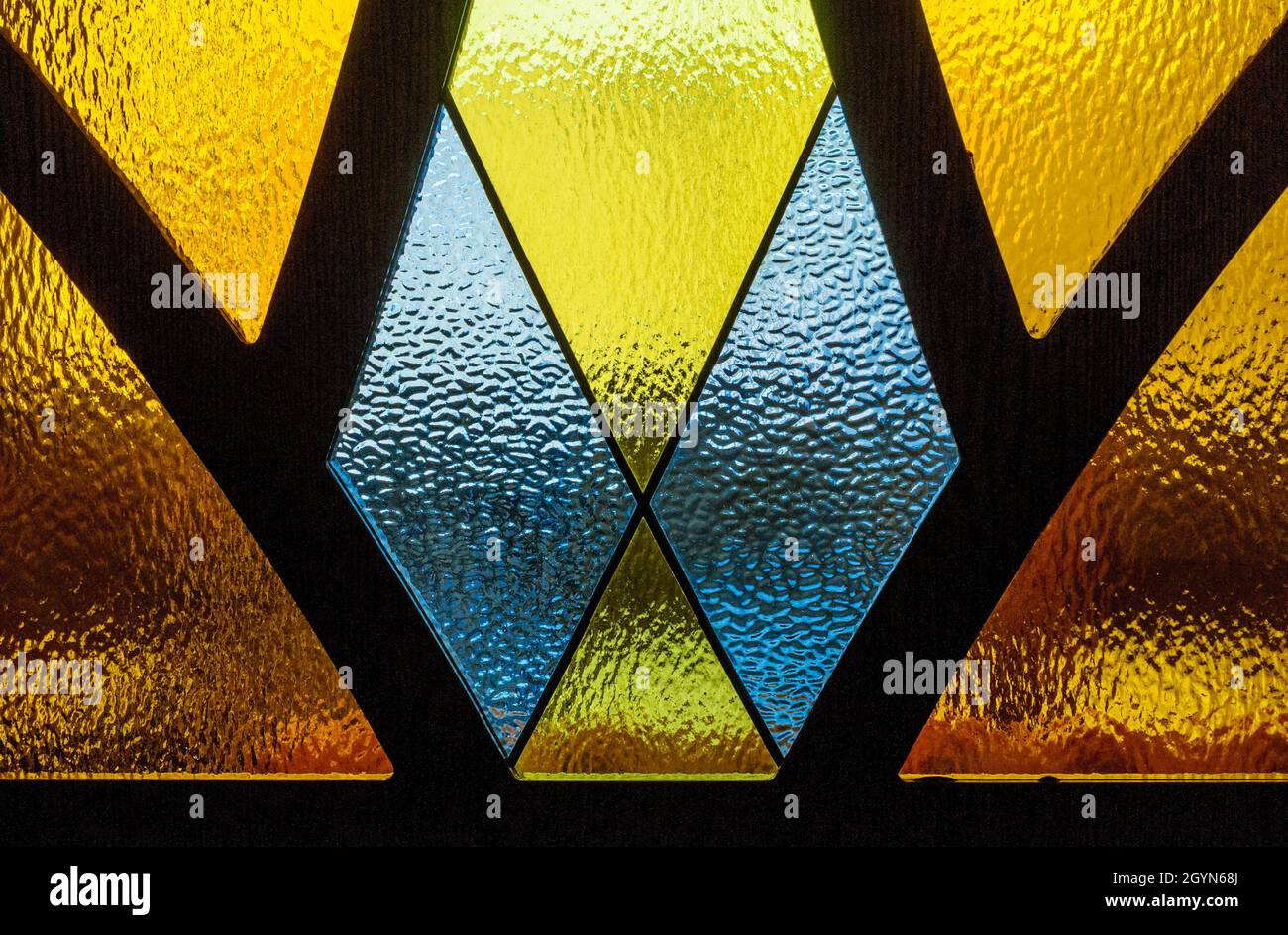 Embossed painted glass with metal separated sections. Geometric shapes with colored glass Stock Photo