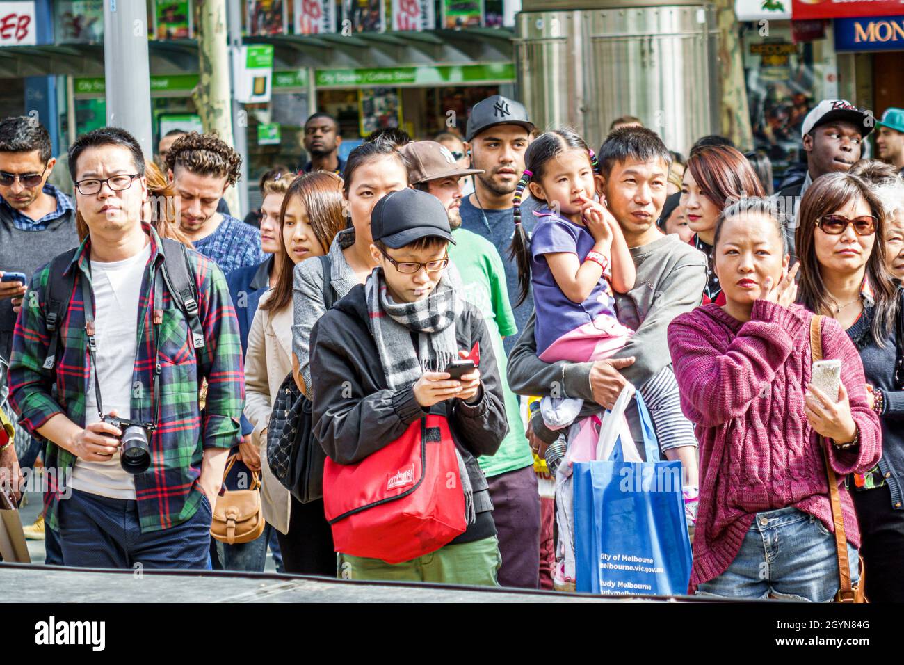 Melbourne Australia,Swanston Street,Asian mother girl daughter father holding family parents child pedestrians,crowded crossing Stock Photo