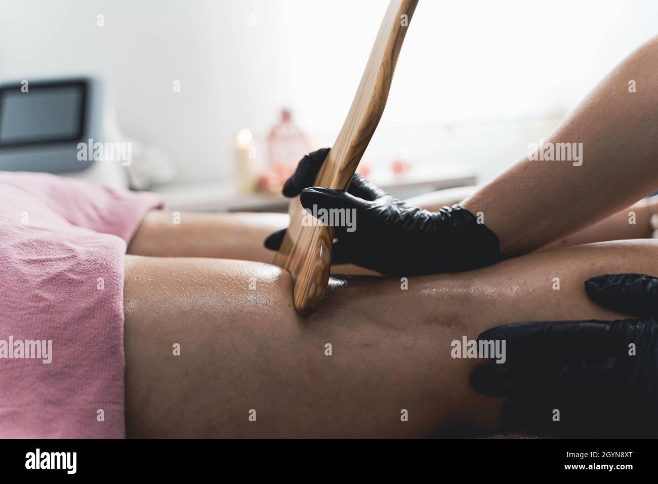 Closeup shot of a Hispanic female getting a massage on a massage table Stock Photo