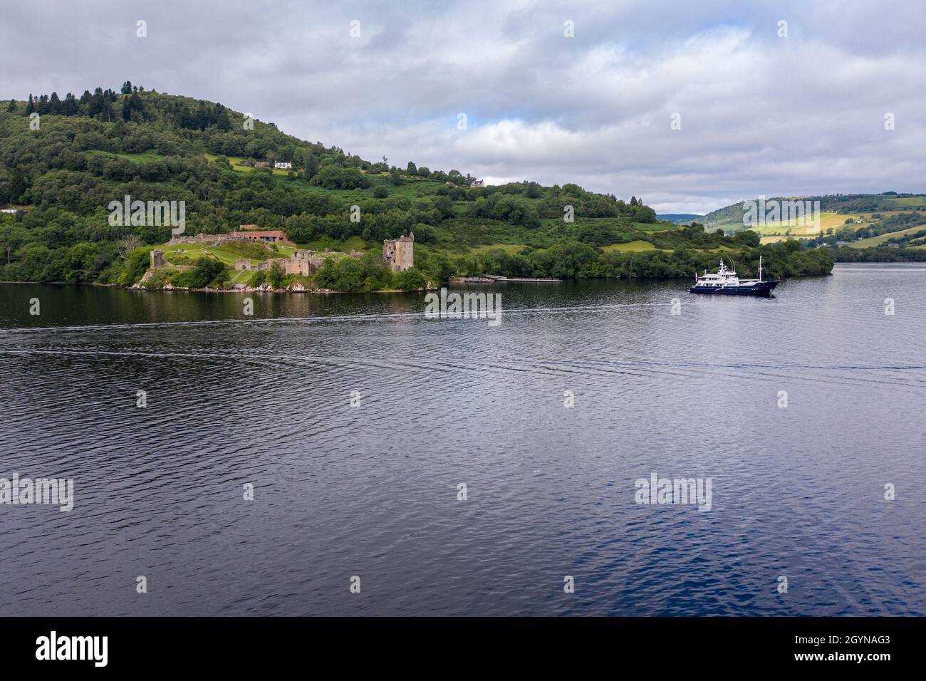 Aerial view Urquhart Castle, a ruin, sits beside Loch Ness in the Highlands of Scotland. Stock Photo