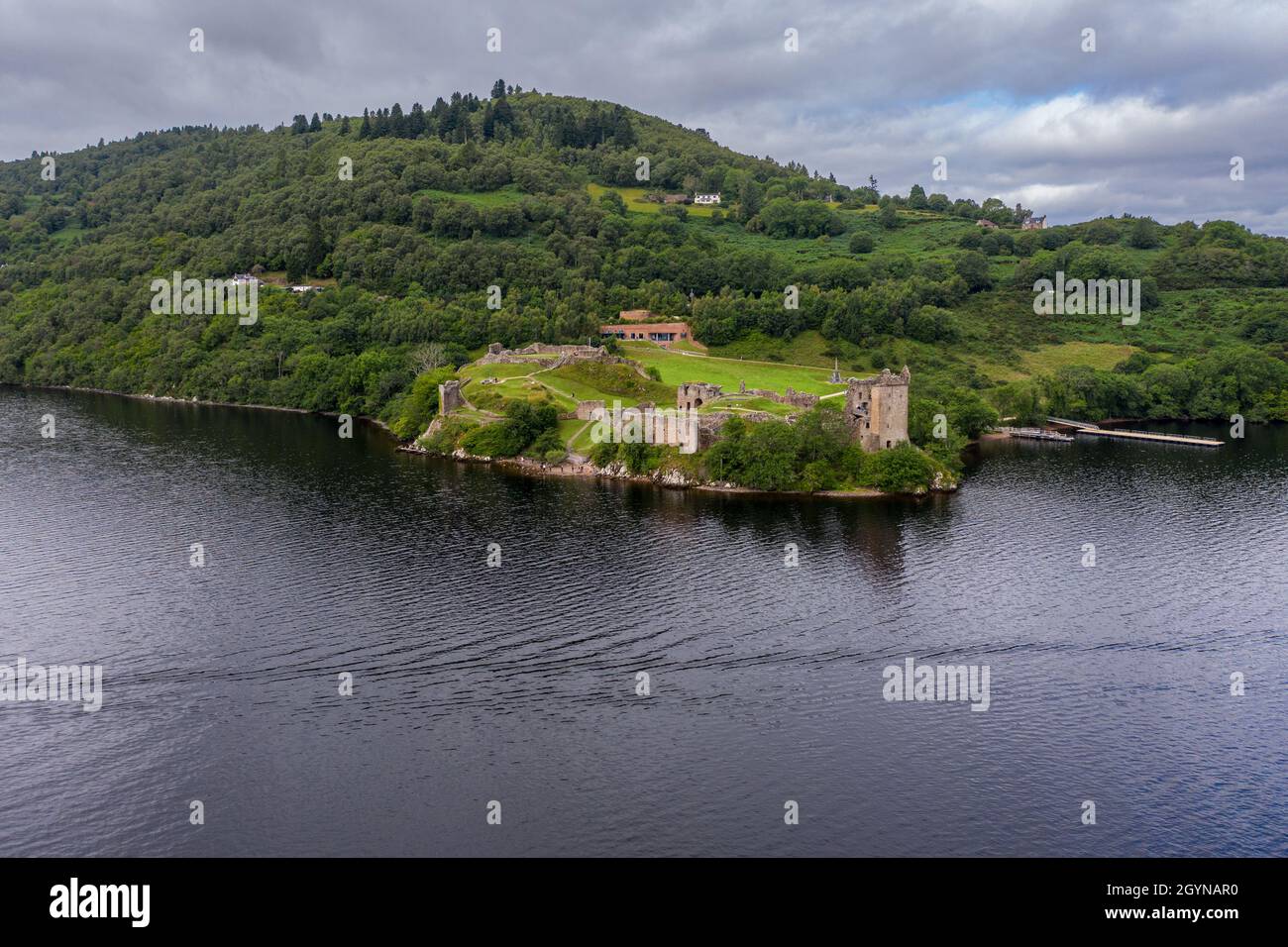 Aerial view Urquhart Castle, a ruin, sits beside Loch Ness in the Highlands of Scotland. Stock Photo
