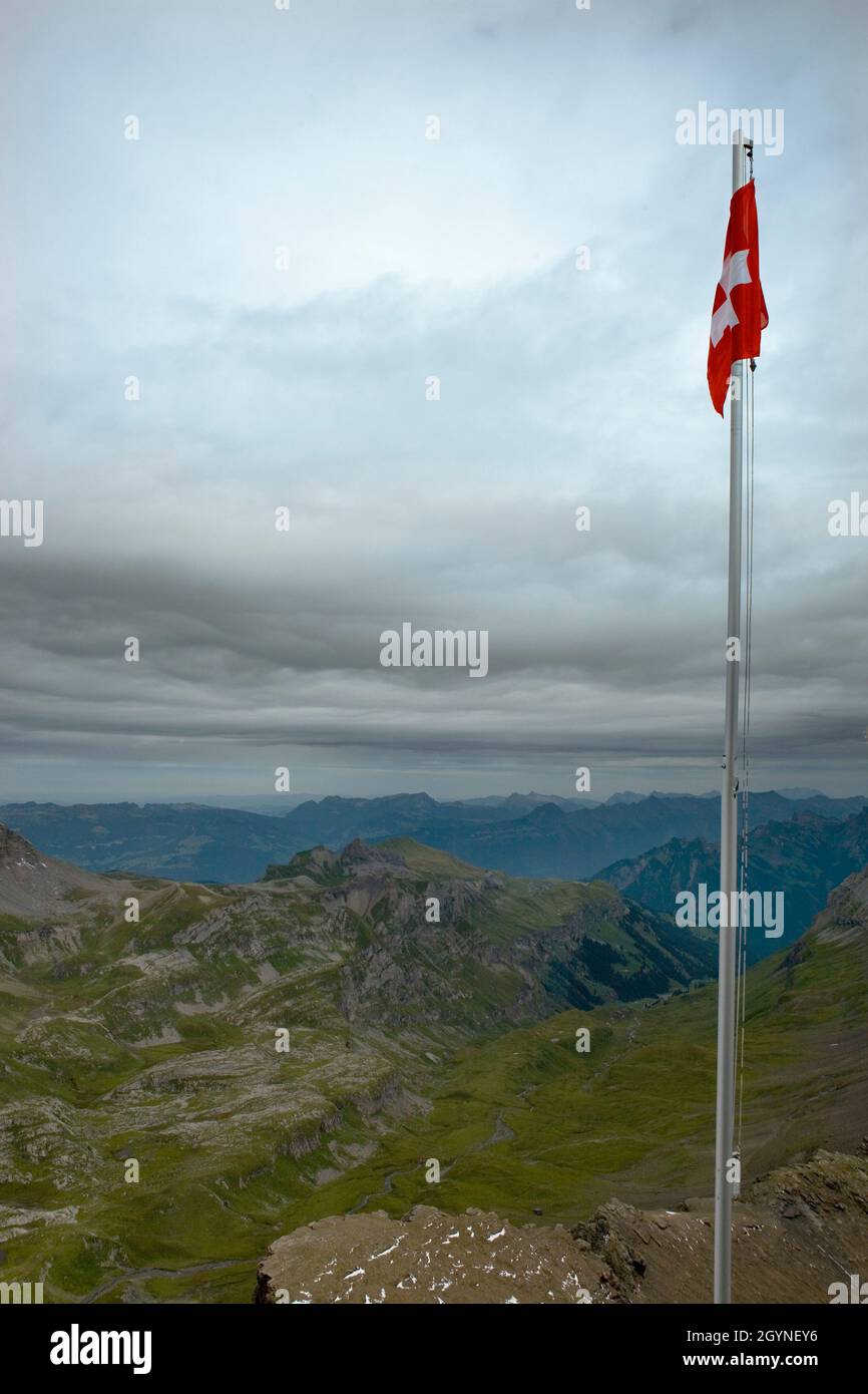 Swiss flag flying on the summit of the Schilthorn, Bernese Oberland, Switzerland Stock Photo