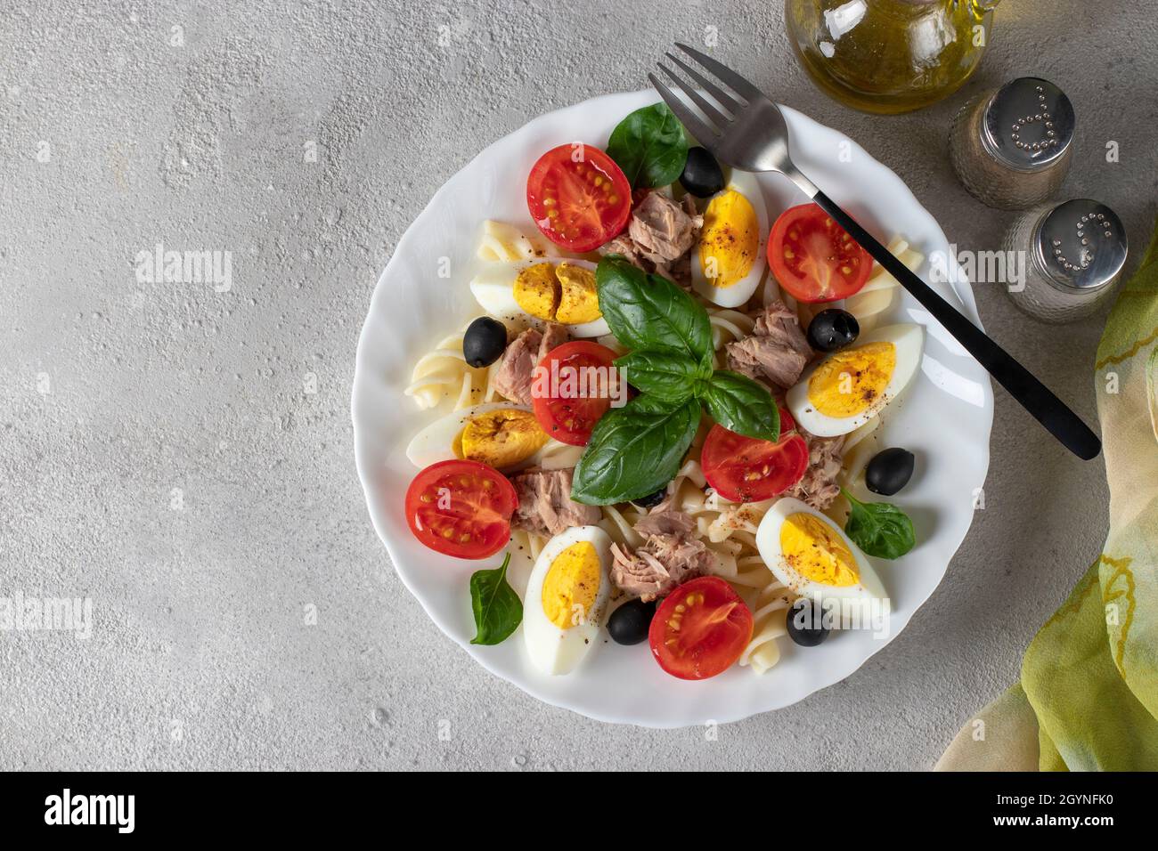 Canned tuna salad with pasta, cherry tomatoes, black olives, boiled egg