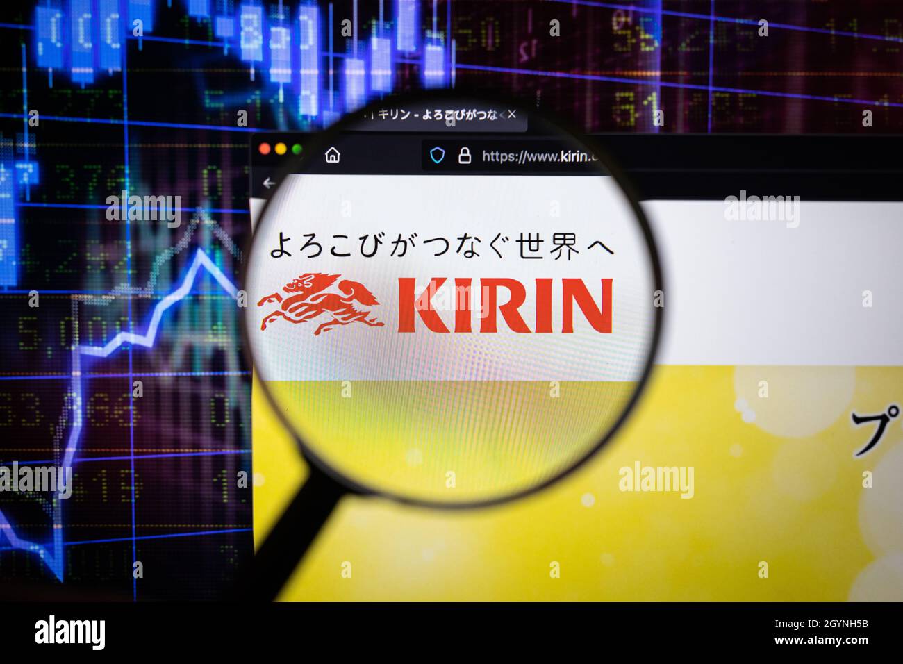 Kirin company logo on a website with blurry stock market developments in the background, seen on a computer screen through a magnifying glass Stock Photo