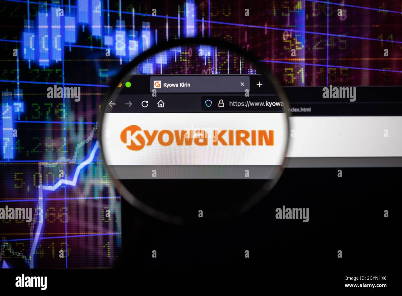Kyowa Kirin company logo on a website with blurry stock market developments in the background, seen on a computer screen through a magnifying glass Stock Photo