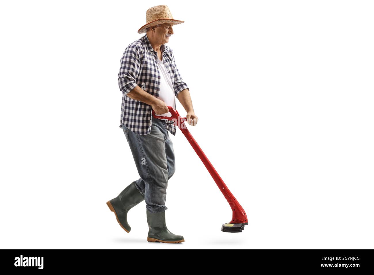 Full length shot of a mature man walking and using a grass trimmer isolated on white background Stock Photo