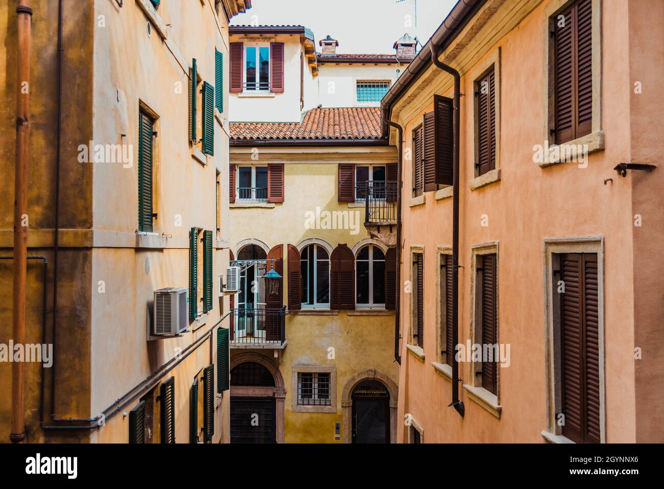 Faded and old facades of houses in the old town of the city of Verona ...