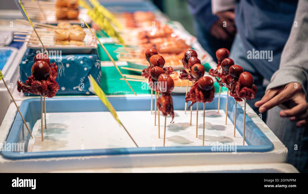 Baby octopus on grill at a food stall hires stock photography and