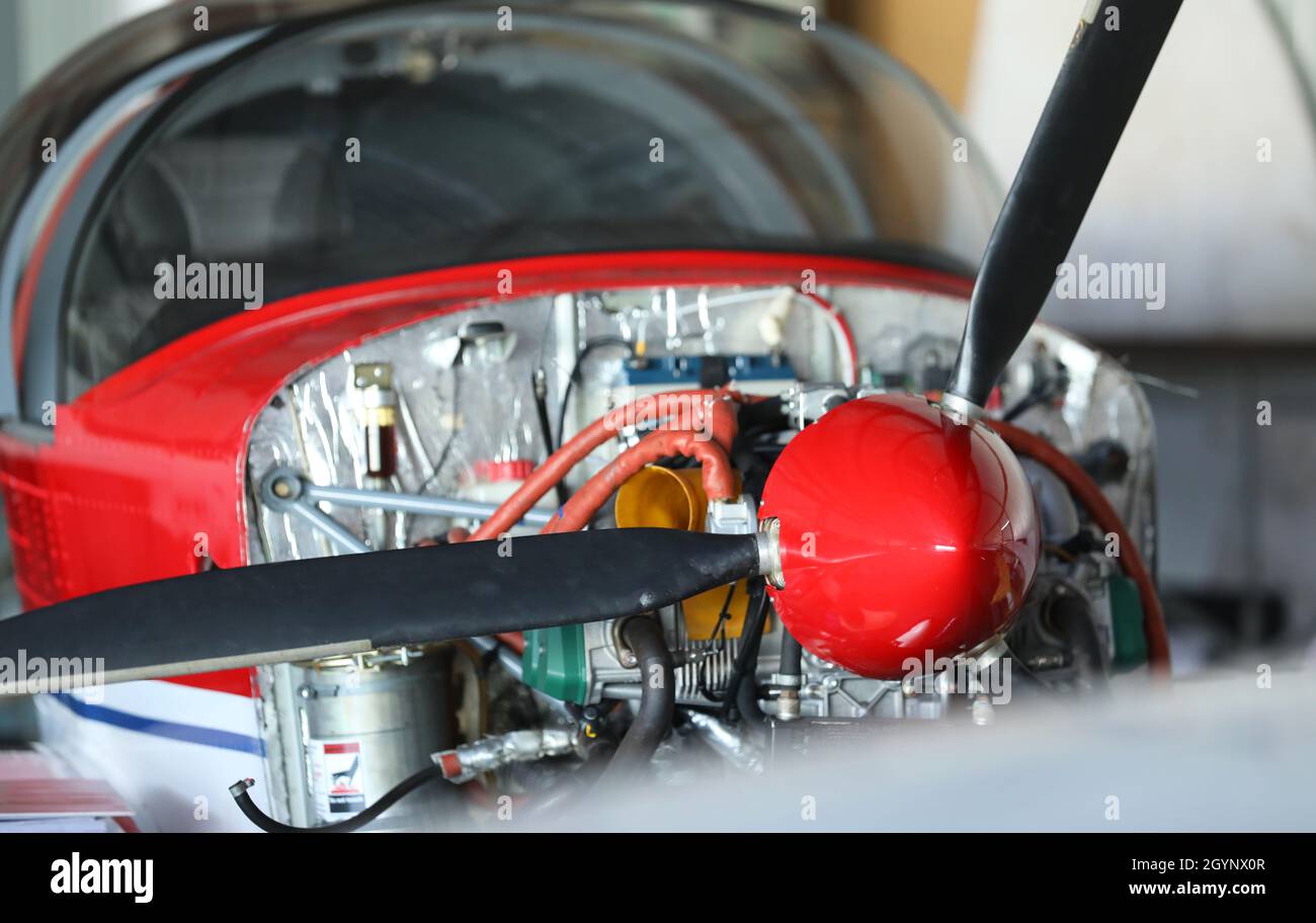 A close up of the engine bay of a small single engine light recreational aircraft. Propeller, motor components and parts visible. Stock Photo