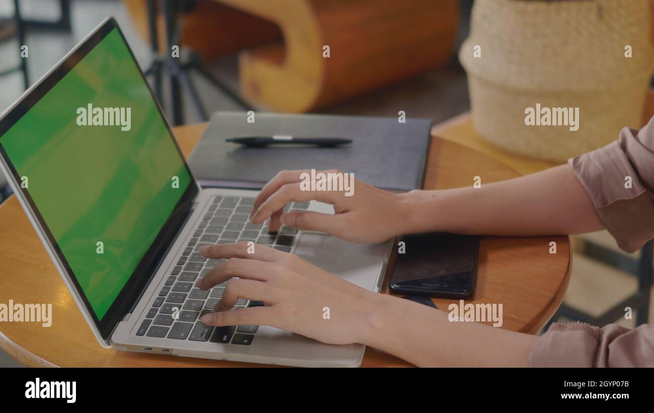 Businesswoman sitting alone working typing keyboard on laptop computer ...