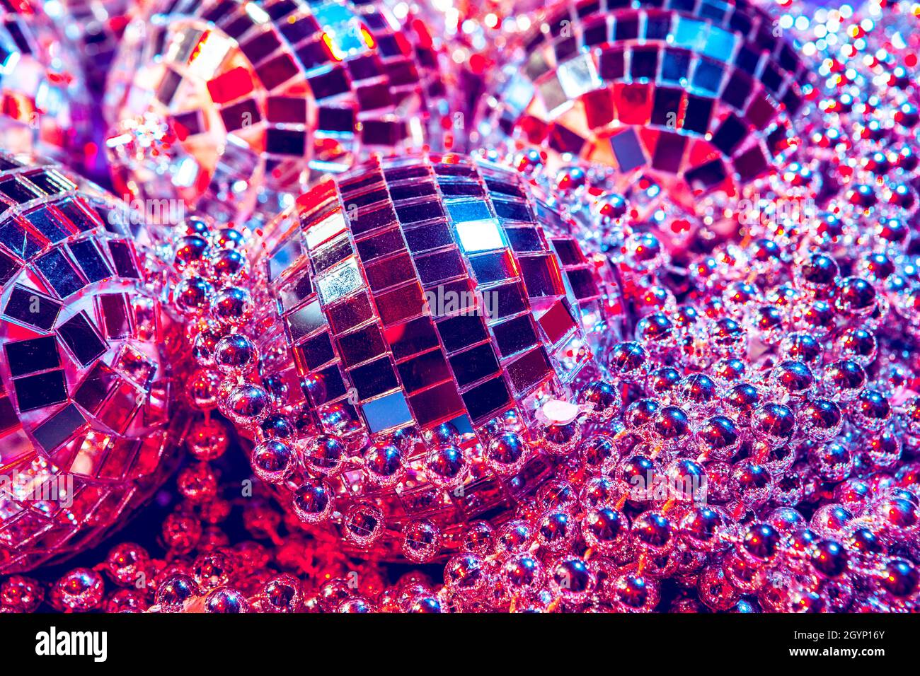 Shiny small disco balls sparkling in a beautiful purple light. Disco party  concept Stock Photo - Alamy