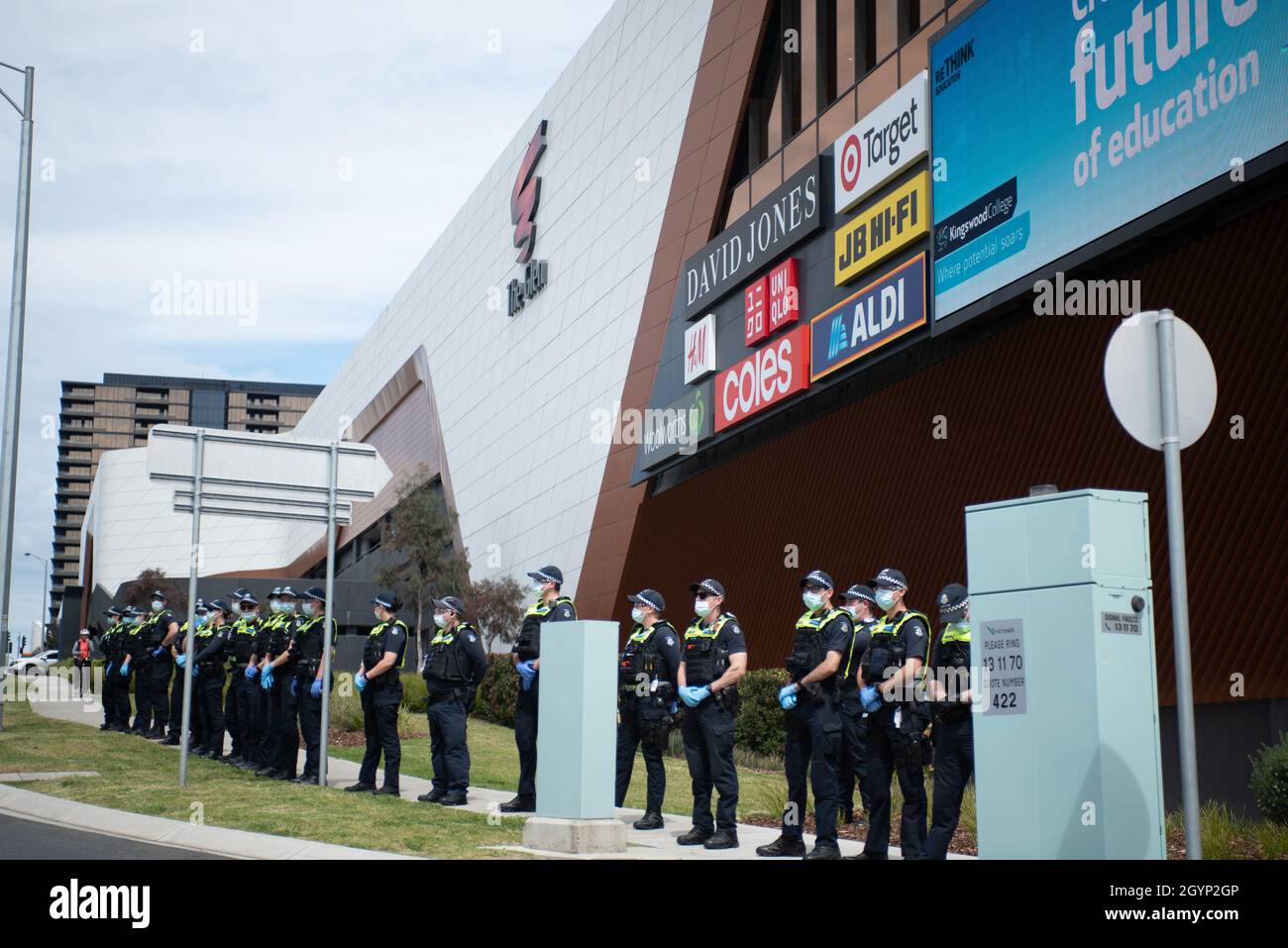 Melbourne, Australia, 9th October 2021. Police line up outside The Glen shopping center, ready to move in on a roadside anti-lockdown protest. Credit: Jay Kogler/Alamy Live News Stock Photo