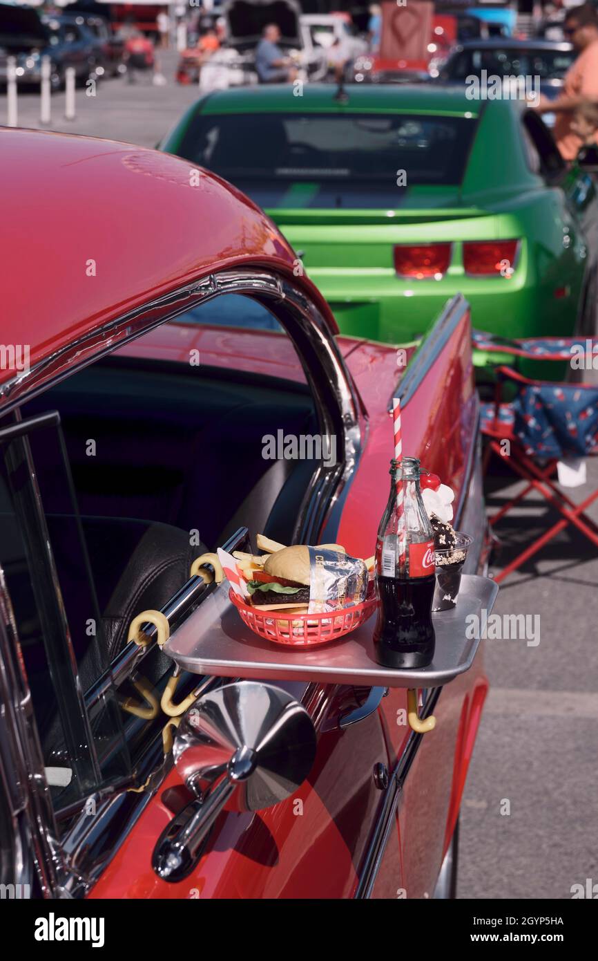 A custom car displays a vintage car hop tray with burger and fries at the 2021 Endless Summer Cruisin in Ocean City Maryland. Stock Photo