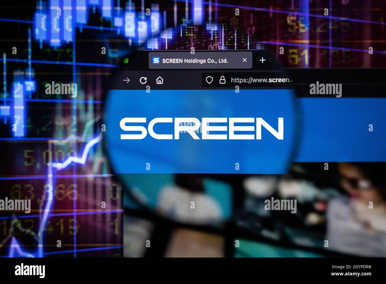 Screen company logo on a website with blurry stock market graphs in the