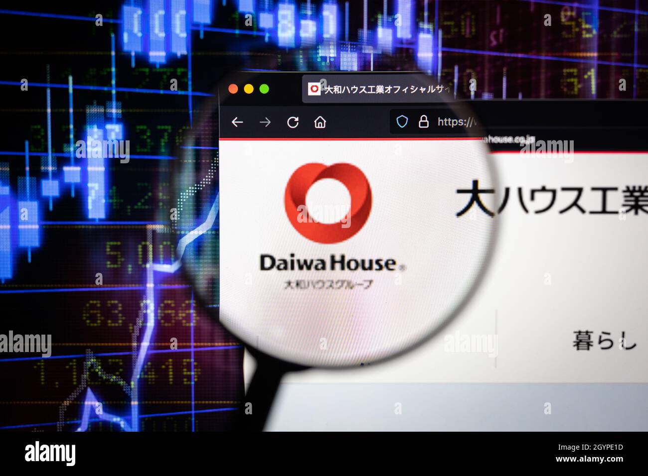 Daiwa House company logo on a website with blurry stock market graphs in the background, seen on a computer screen through a magnifying glass. Stock Photo