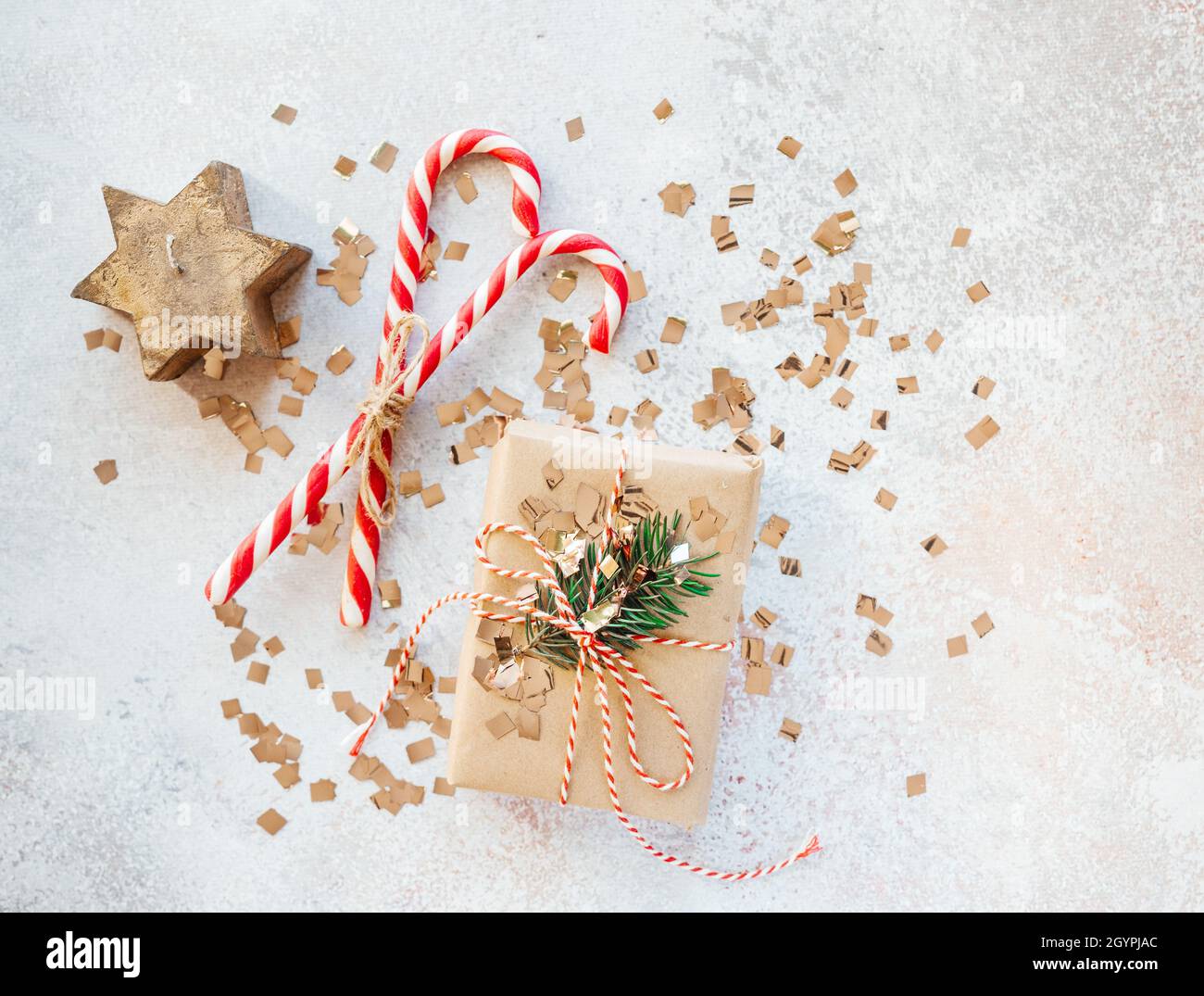 Christmas gift box wrapped in kraft paper, candy canes and Christmas ...