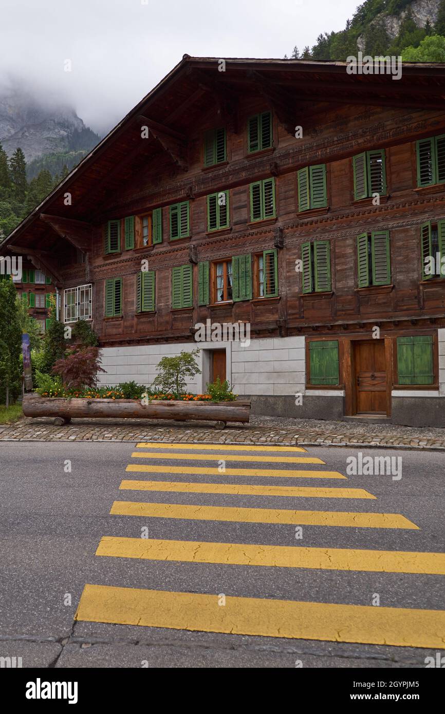 Swiss chalet and zebra crossing - Simmental, Berner Oberland, Switzerland Stock Photo