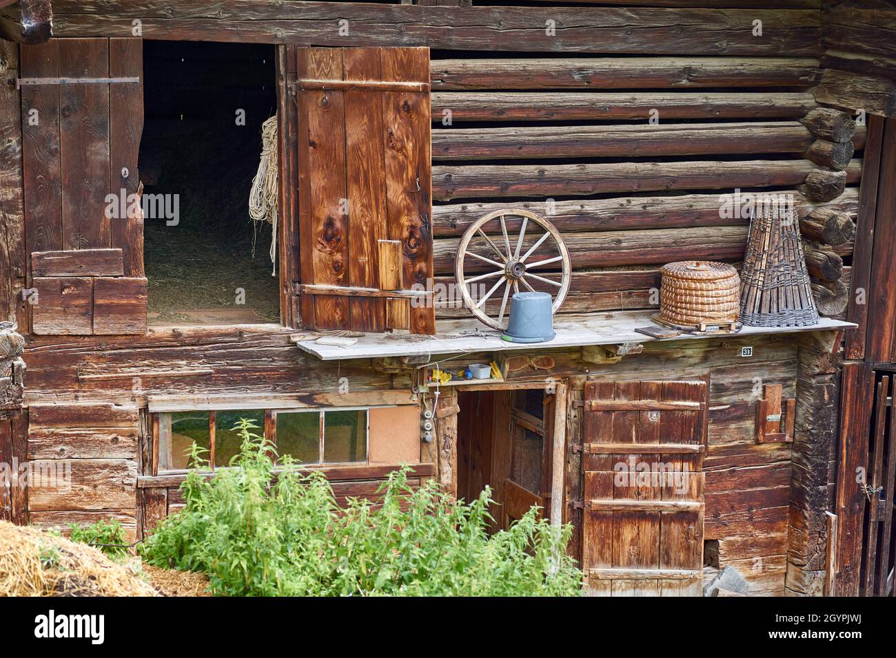 Swiss chalet shed with old farm tools - Simmental, Berner Oberland, Switzerland Stock Photo