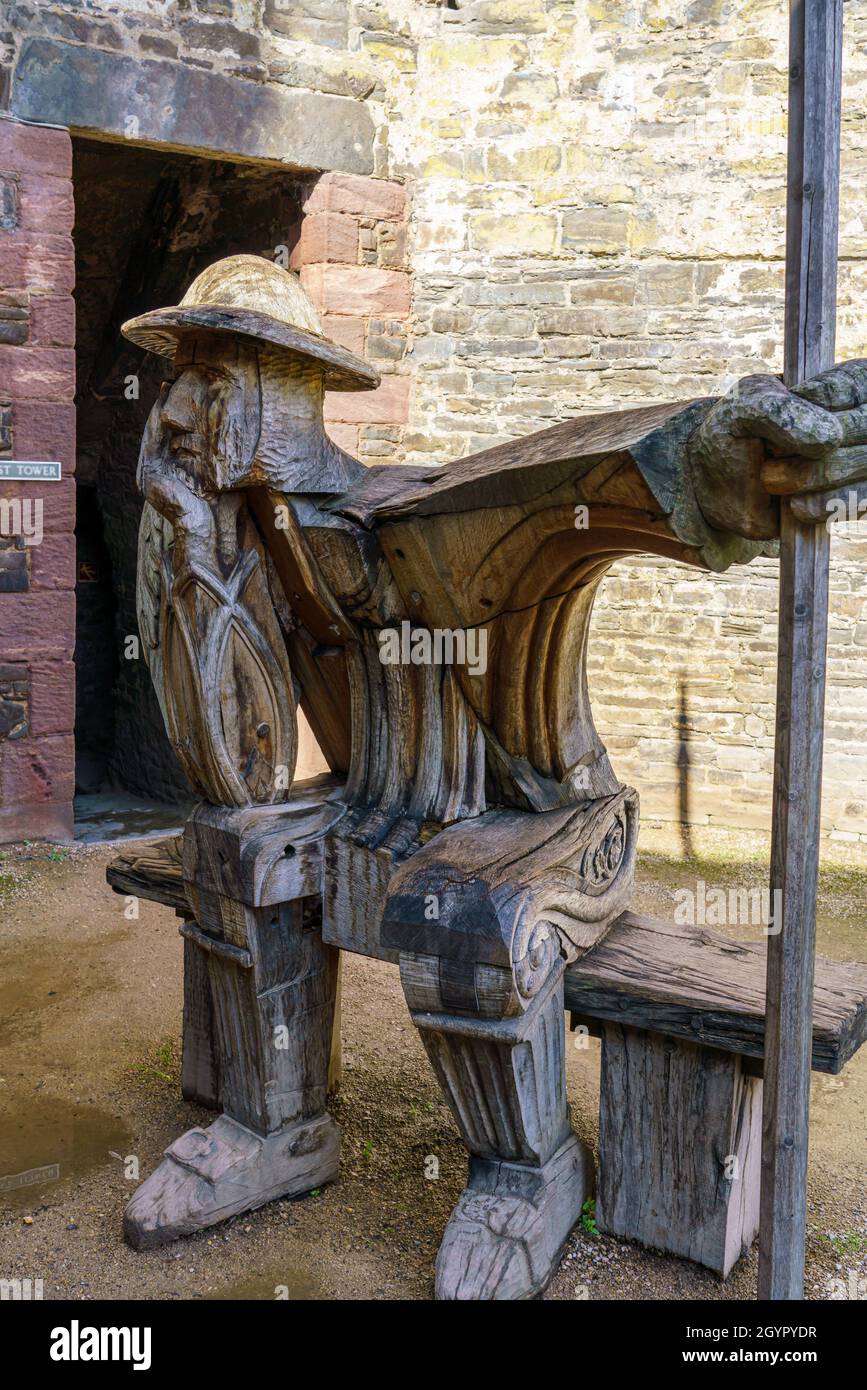 'The Guard' a wooden oak sculpture by John Merrill inside Conwy Castle ruins, Wales, UK Stock Photo