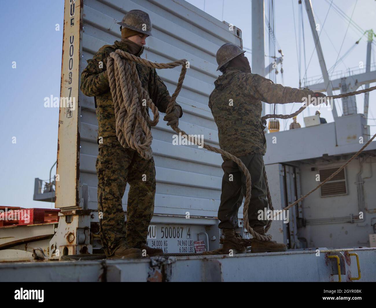 Marine Lance Cpl. Christopher Urban, left, and Cpl. William Hemphill pull rope while guiding a crane in support of exercise Carolina Patriot 2020 in Philadelphia, Pennsylvania, Jan. 22, 2020. The exercise ensures 2nd Marine Aircraft Wing’s proficiency and readiness in aviation logistics support operations. Urban is an aircraft intermediate level hydraulic/pneumatic mechanic with Marine Aviation Logistics Squadron (MALS) 26. Hemphill is an aircraft intermediate level structures mechanic with MALS-26. (U.S. Marine Corps photo by Cpl. Cody Rowe) Stock Photo