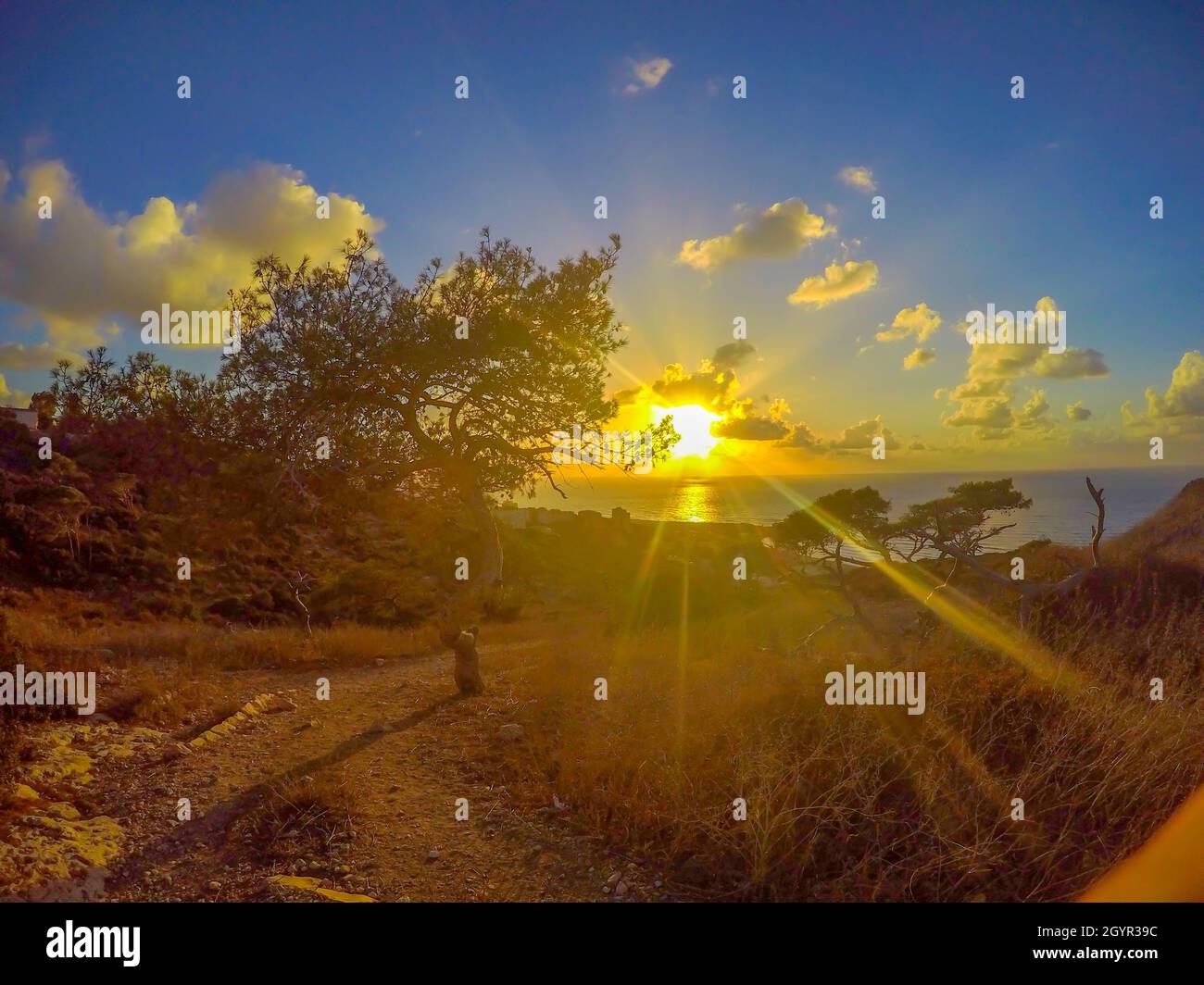 Yellow sun rays at sunset over the Mediterranean Sea Stock Photo